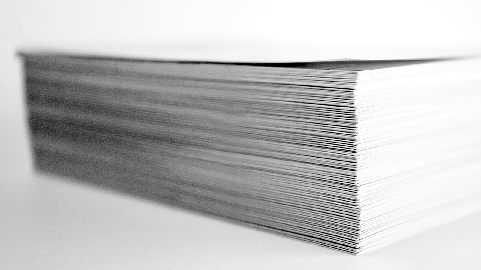 A tall stack of white business cards