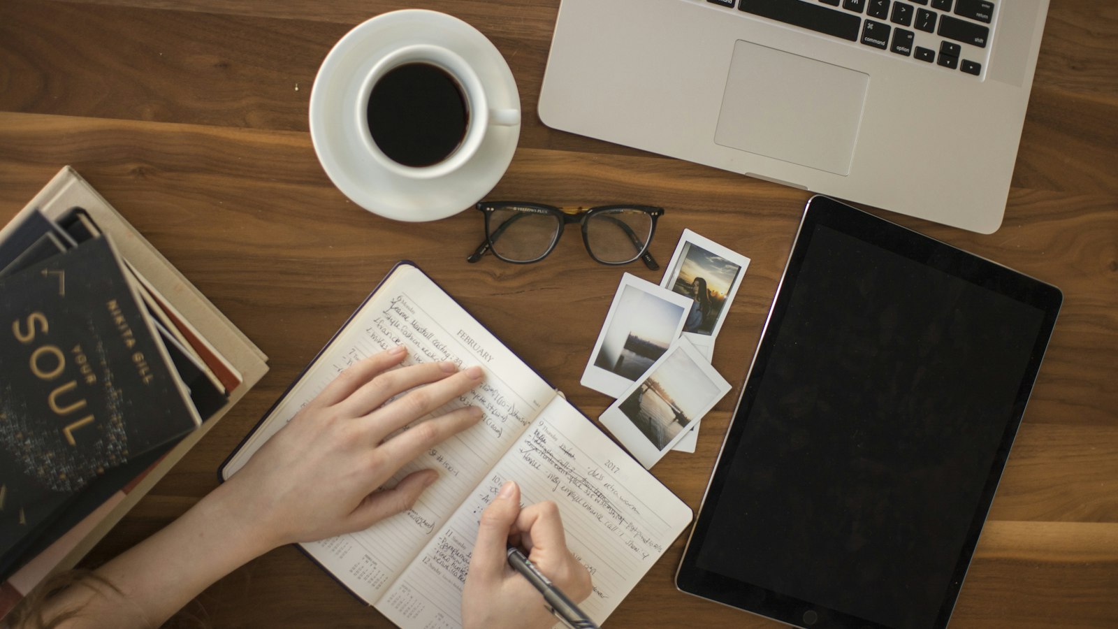 Handwritten notes and a coffee on a desk, from above
