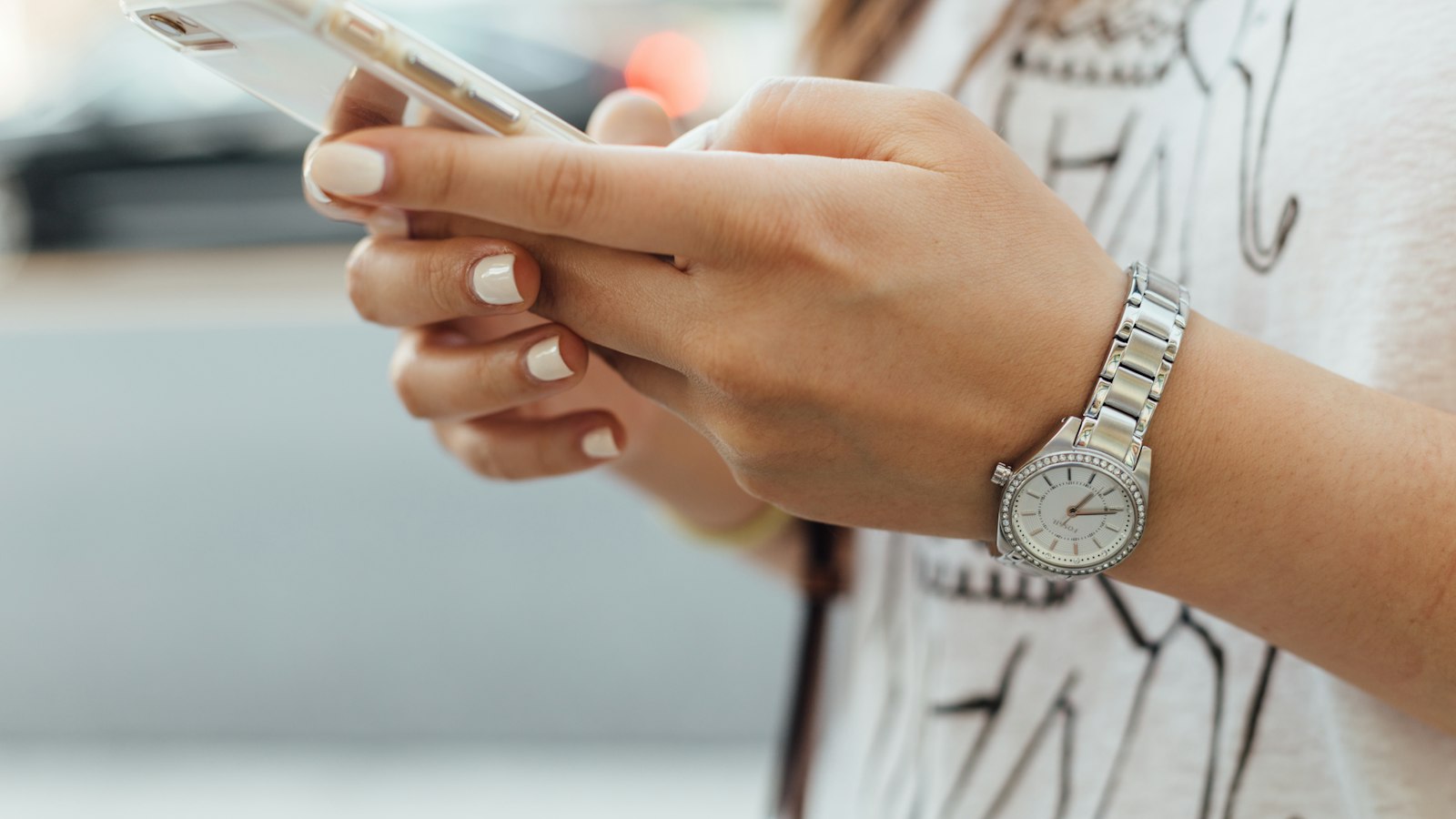 Hands typing a message on a phone